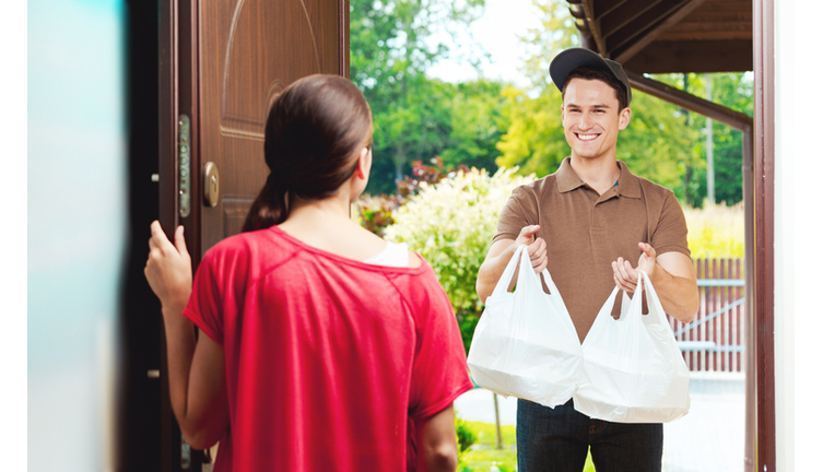 Delivery man delivering chinese take away food