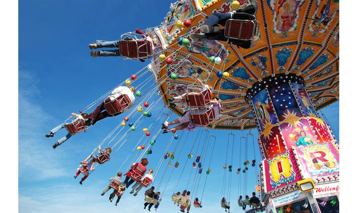 Families at the fair on a swing ride