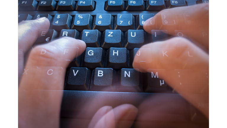 Very fast writing on a modern black keyboard