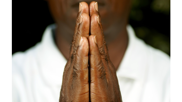 fingers of afro man in prayer