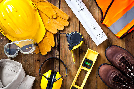 Personal safety workwear and construction blueprint shot directly above