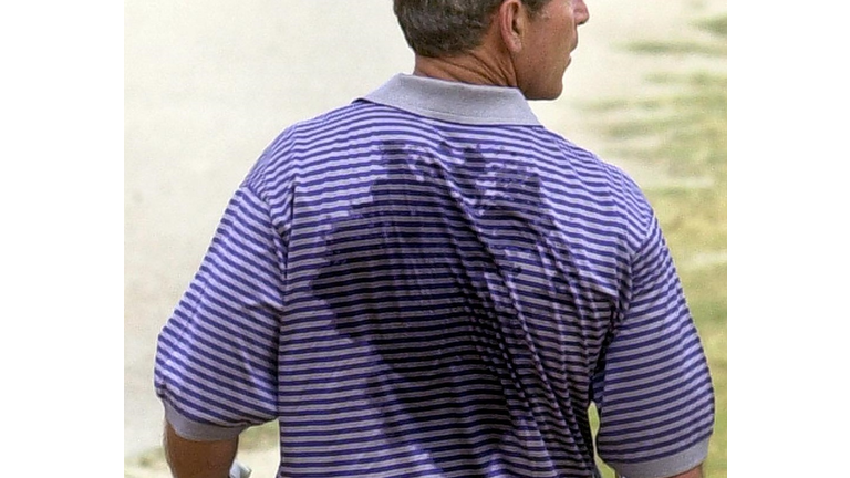 US President George W. Bush, his shirt drenched in