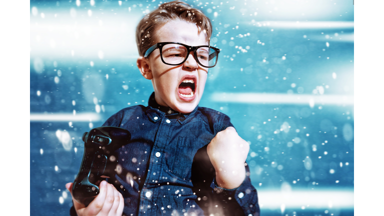 Kid with game controller wins sport match and cheers