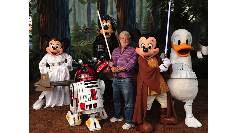 George Lucas Poses With A Group Of "Star Wars" Inspired Disney Characters At Disney's Hollywood Studios
