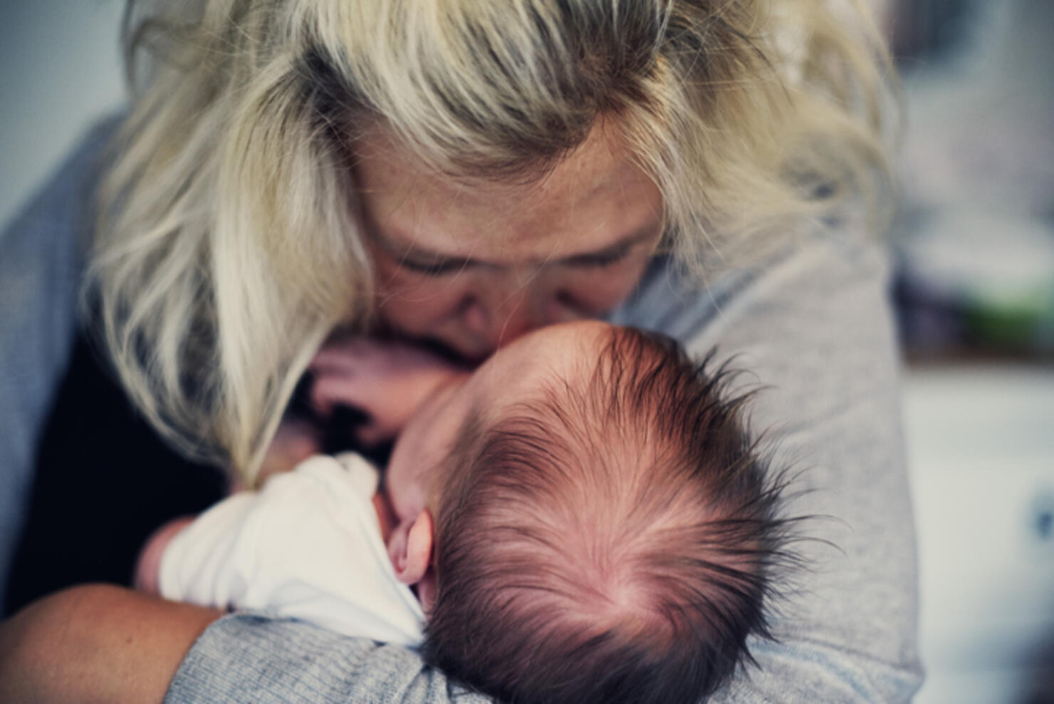 Mother kissing newborn baby