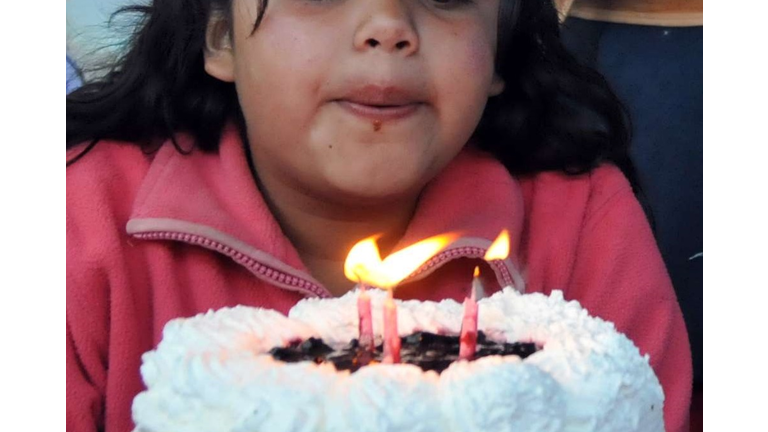 A clown livens up the birthday party of