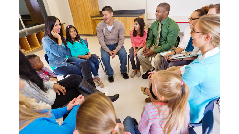 Conference or meeting with elementary school teachers students and parents