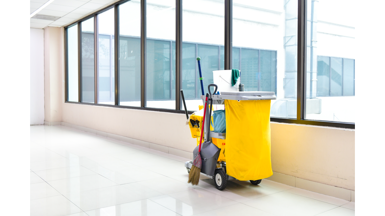 Cleaning tools cart wait for cleaning,Yellow mop bucket and set of cleaning equipment in the airport