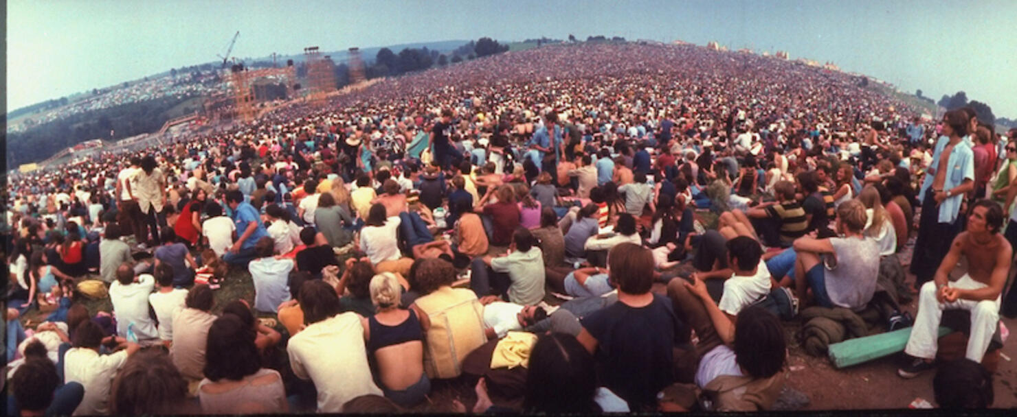Wide-angle overall of huge crowd facing