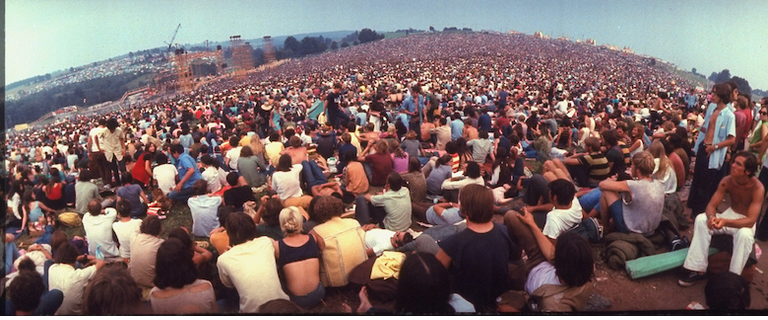 Wide-angle overall of huge crowd facing