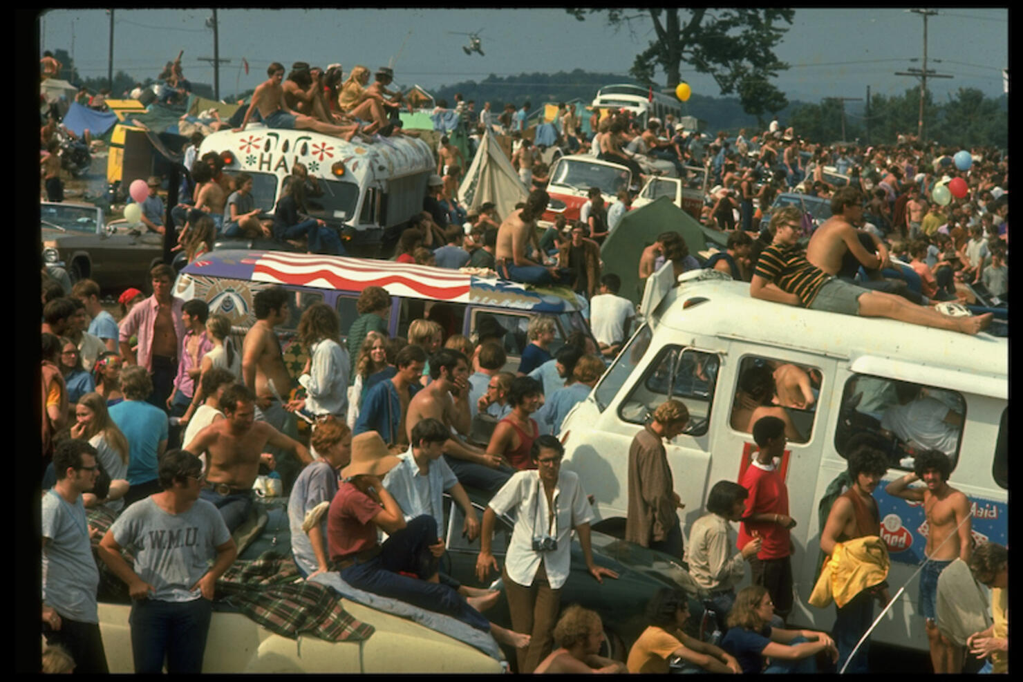 Large crowd of people, incl. people sitting on top
