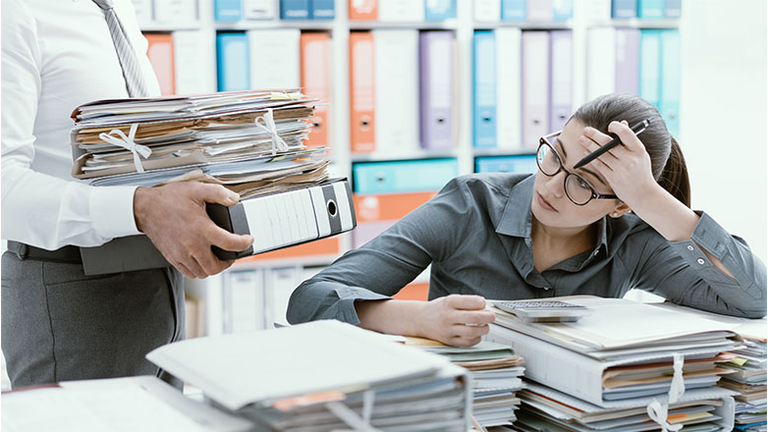 Young secretary overwhelmed by work