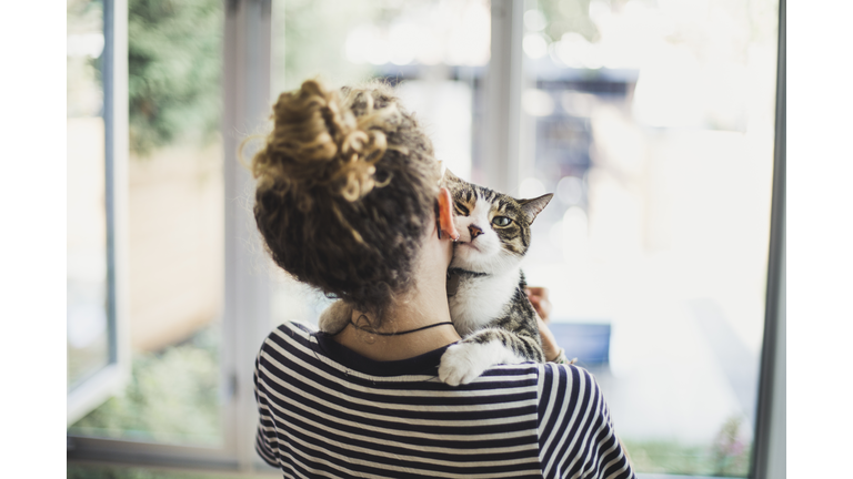 A teenager girl holding her cat