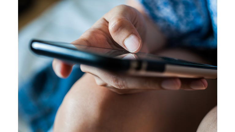 A woman is using a mobile phone
