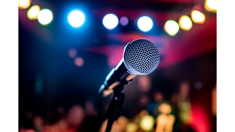 Microphone on stage against a background of auditorium.