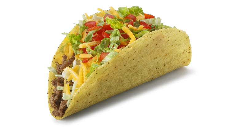 Classic taco isolated on white background with soft shadow