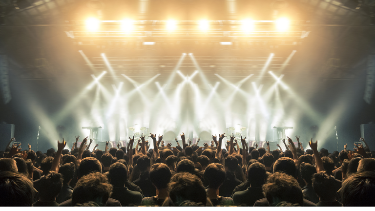 Concert arena with fans clapping