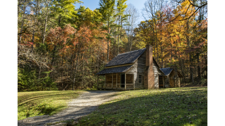 The Henry Whitehead homestead located in Cades Cove in the Great Smoky Mountains National Park is surrounded by colorful fall foliage.