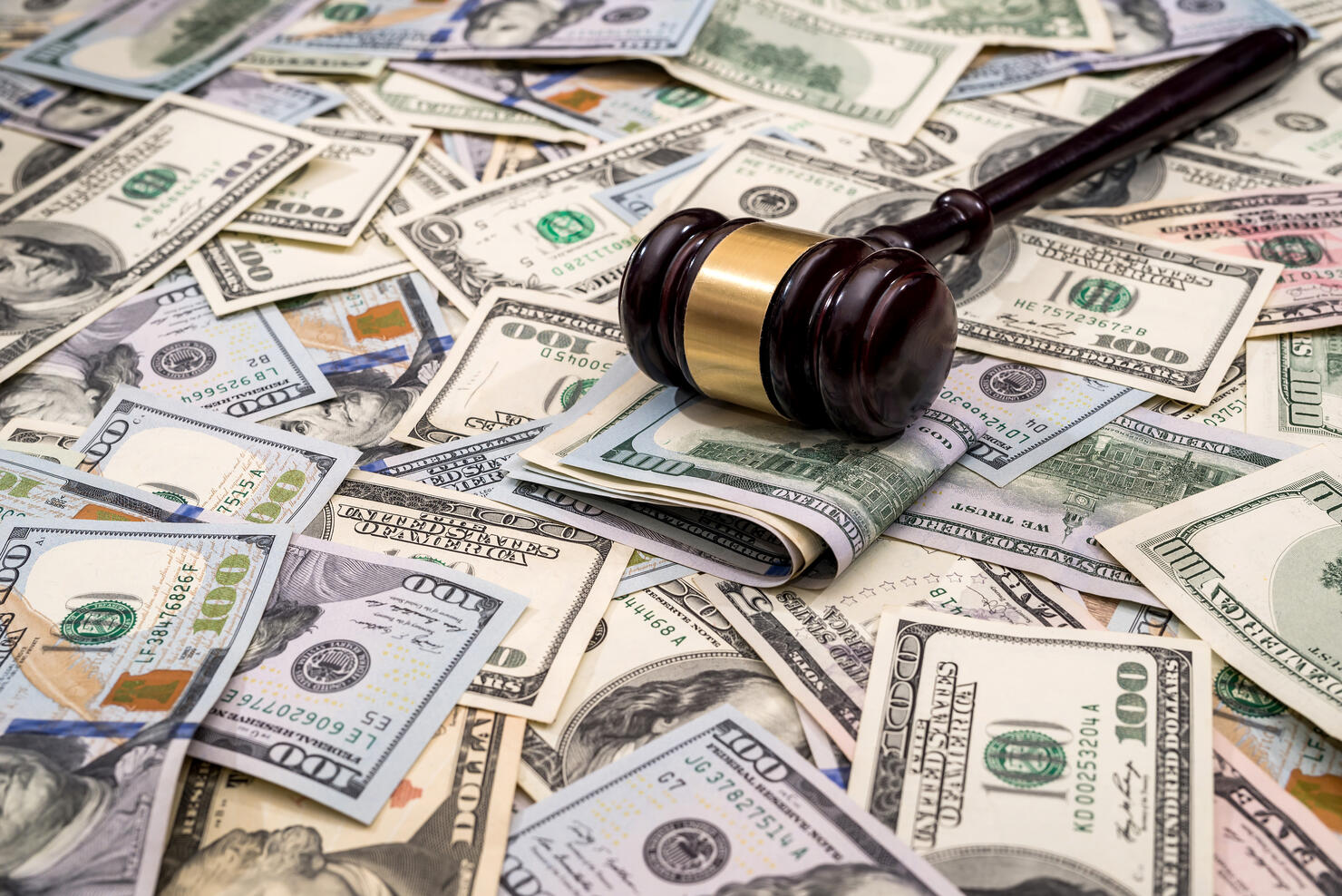 wooden hammer judge against the background of dollars