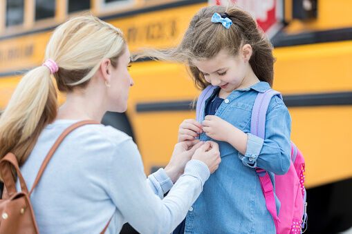 Loving mom prepares daughter for first day of school