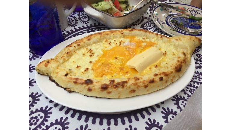 Signature dish of Khatchapuri.  Canoe shaped pizza!