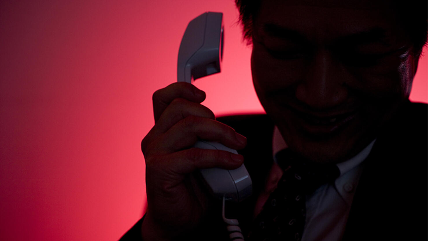 Silhouette of man making a phone call