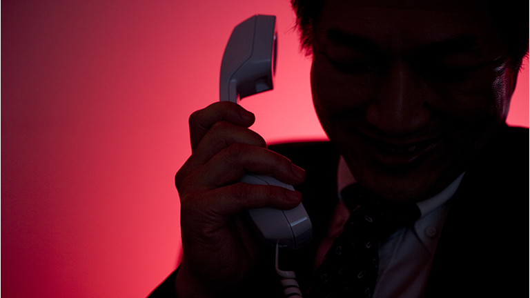 Silhouette of man making a phone call