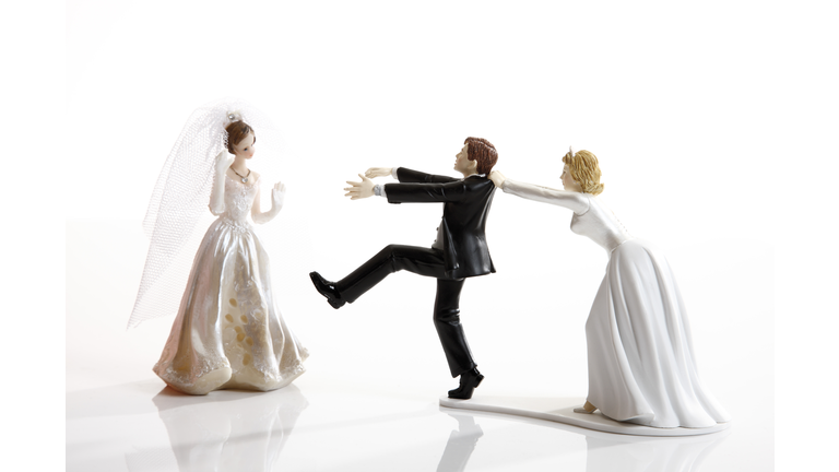 Wedding cake visual metaphor with figurine cake toppers