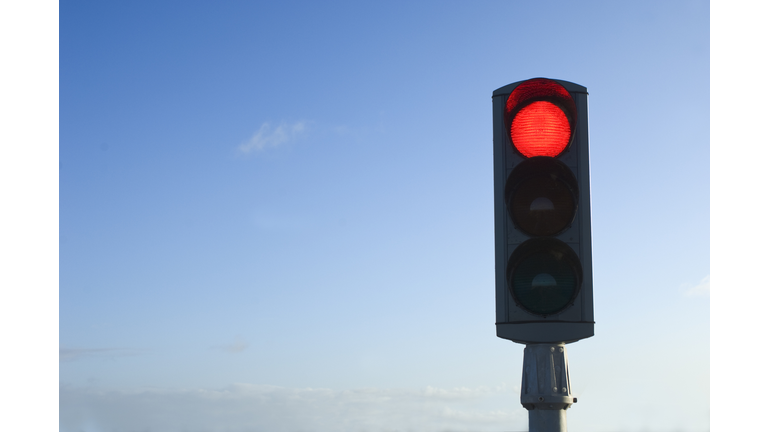 Traffic Light on Red Isolated Against Blue Sky