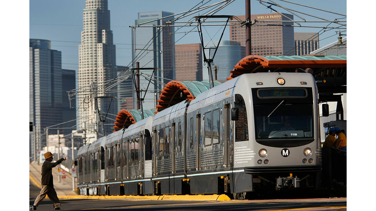 On it's way to East Los Angeles, a passenger crosses the street to catch the Metro Gold Line Eastsi