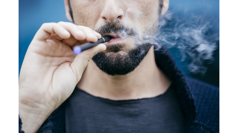 Portrait of man smoking an electronic cigarette