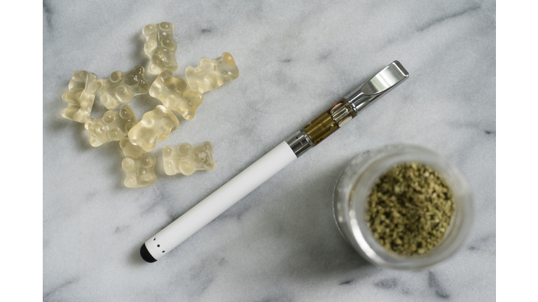 Gummi bear edibles, electronic cigarette, and marijuana in jar