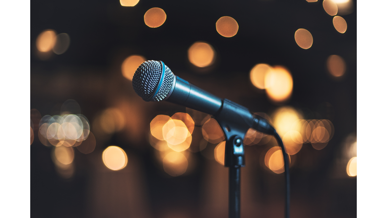 Microphone on stage against a background concert or show