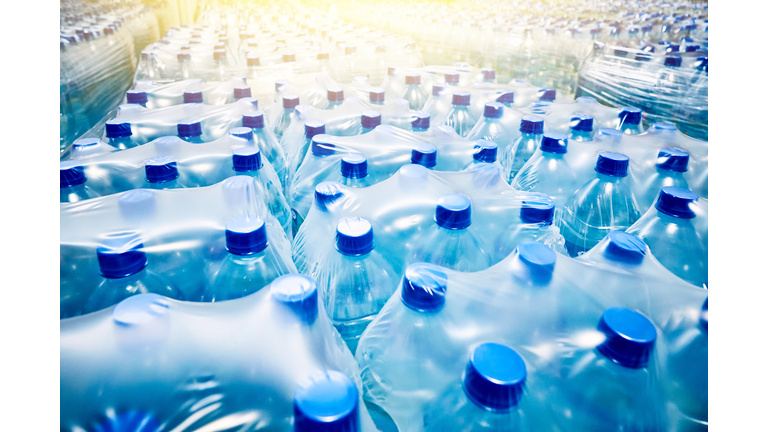 Many packaged blue mineral water bottles