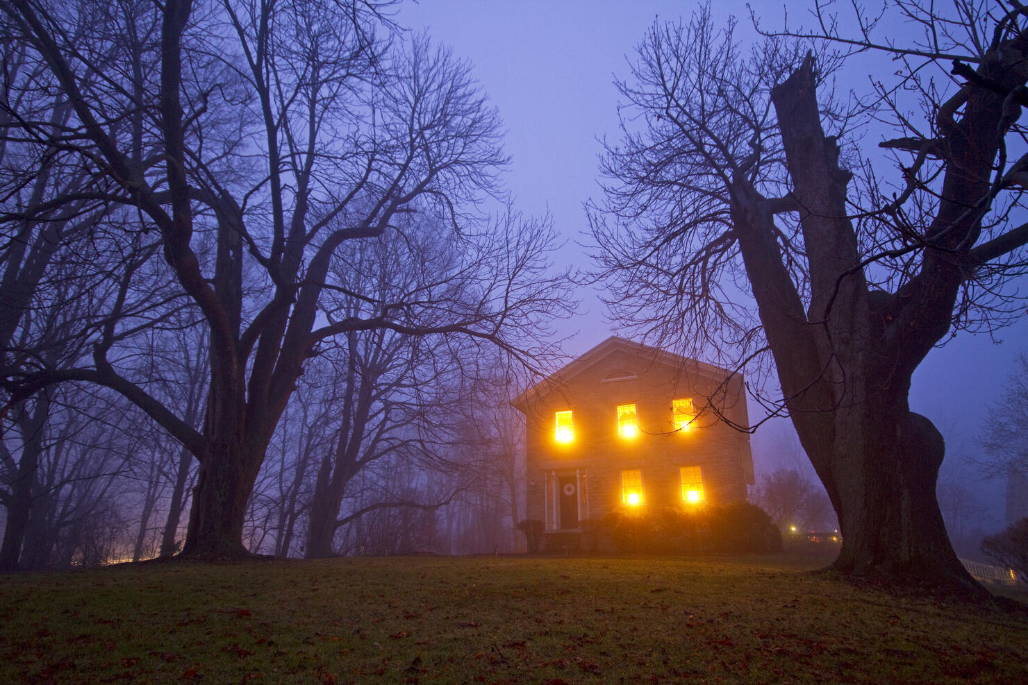 Old stone house on foggy night