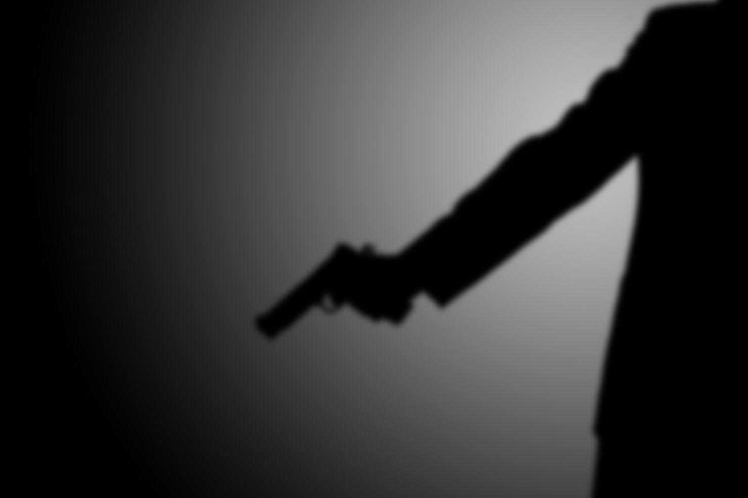 gunman killer shooting. light and shadow