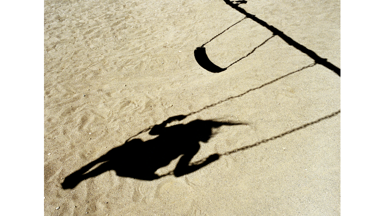 Shadow of girl on swing