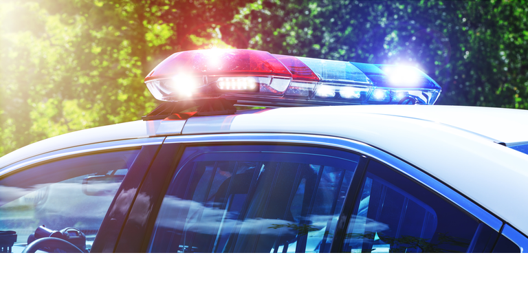 Police car with focus on siren lights. Beautiful siren lights activated in full mission activity. Policemen with patrol car in intervention operation at crime place. Emergency lights flashing on patrol car.