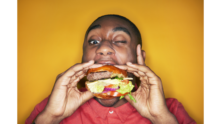 man eating hamburger