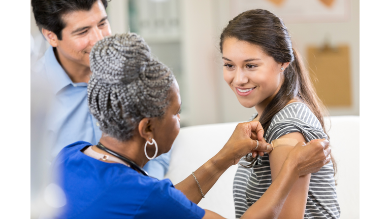 Nurse places bandage on female patient