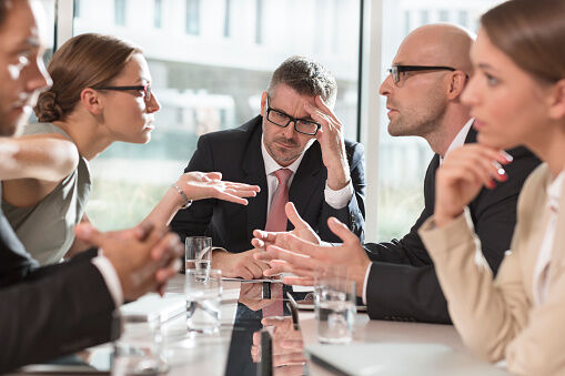 Five business people having an argument