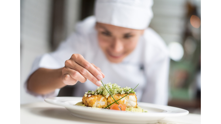 Cook decorating a plate