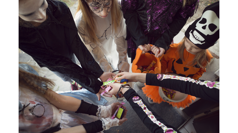 Group of children trick or treating for sweets on Halloween
