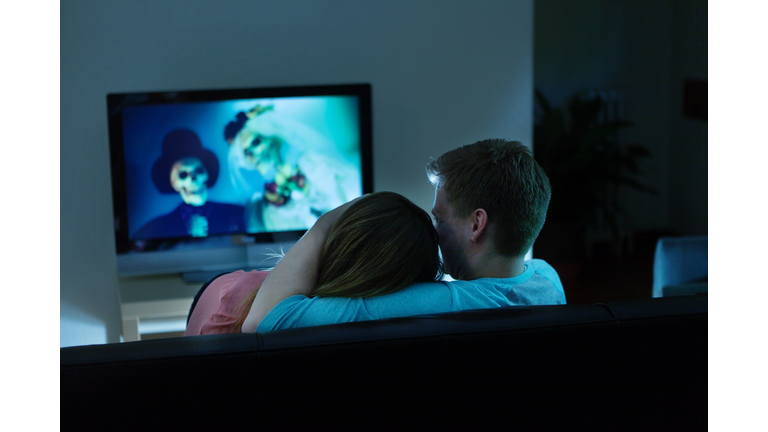 Couple Watching Scary Halloween Movie Together on TV