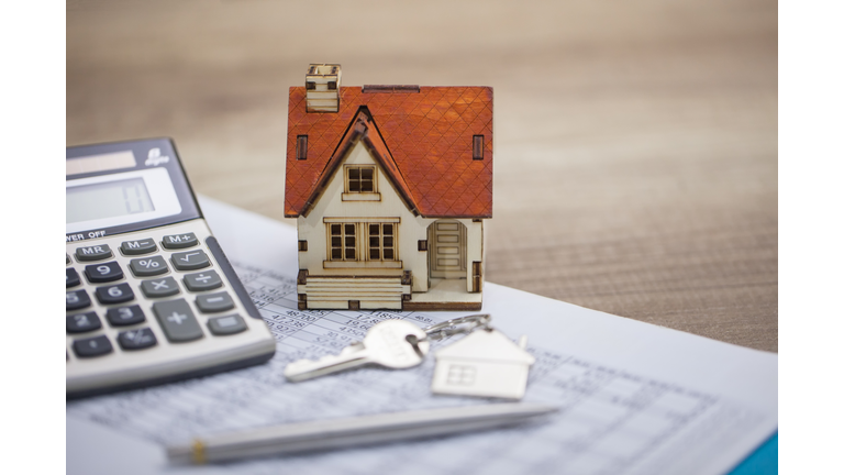 House model and calculator on table for finance ,selling home concept., bangking concept