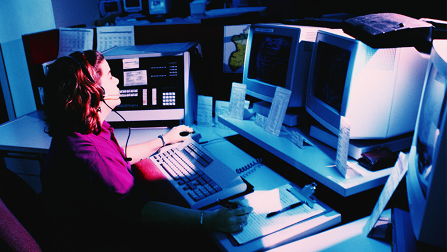 Woman working at police dispatch terminal