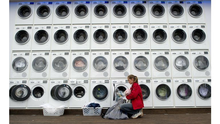 People do their laundry at a wall of was