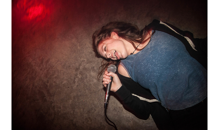 Young Woman sings in bar