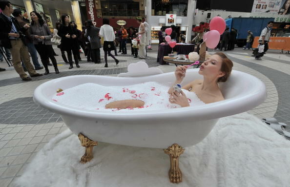 A model sits in a bathtub to promote a s