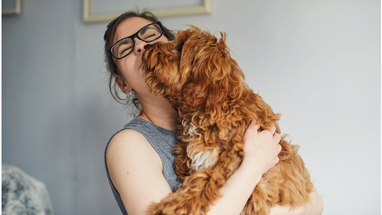 Woman holding her pet dog